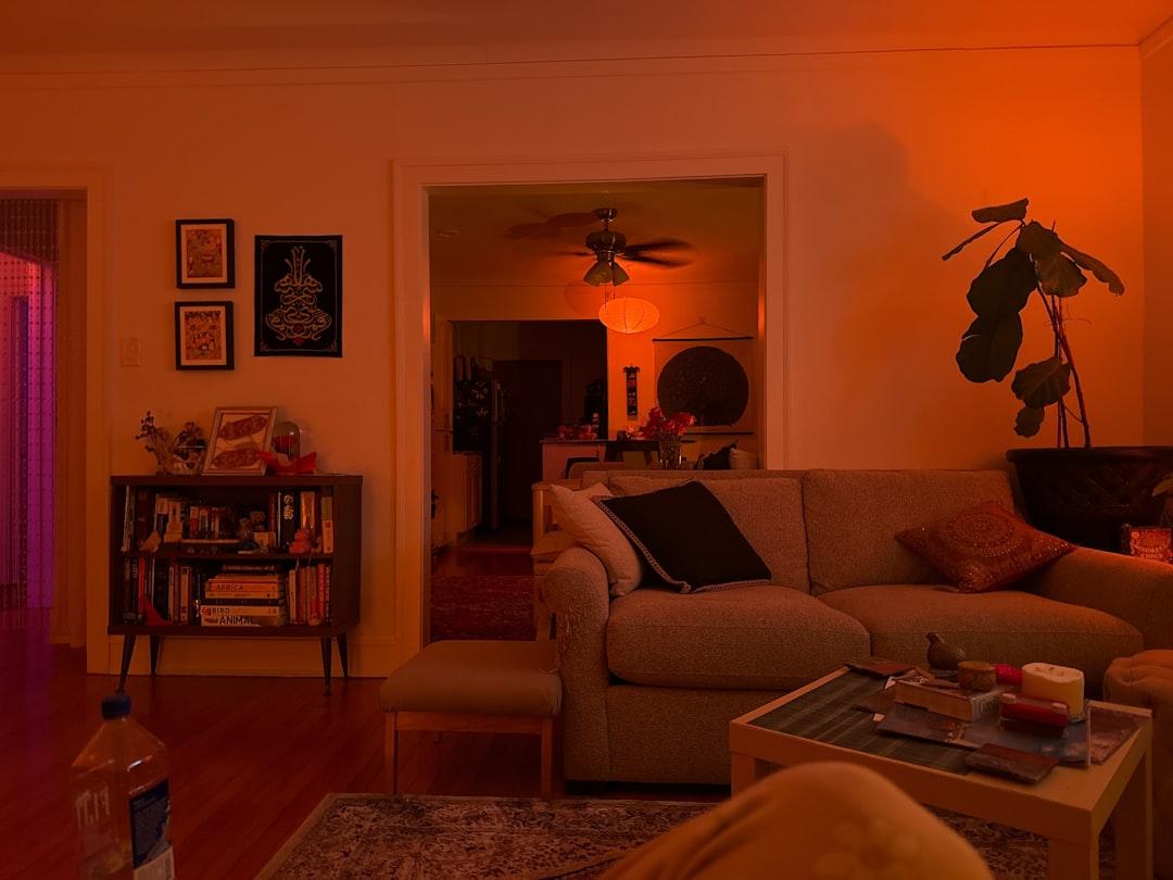 Before-and-after living room photo showing low-light noise reduced and color balanced