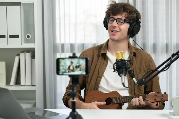 Music vlogger singing and playing guitar in studio