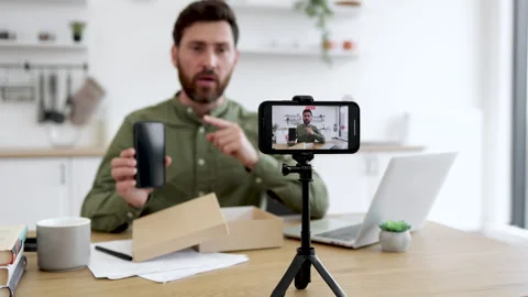 Tech vlogger unboxing a new gadget on camera