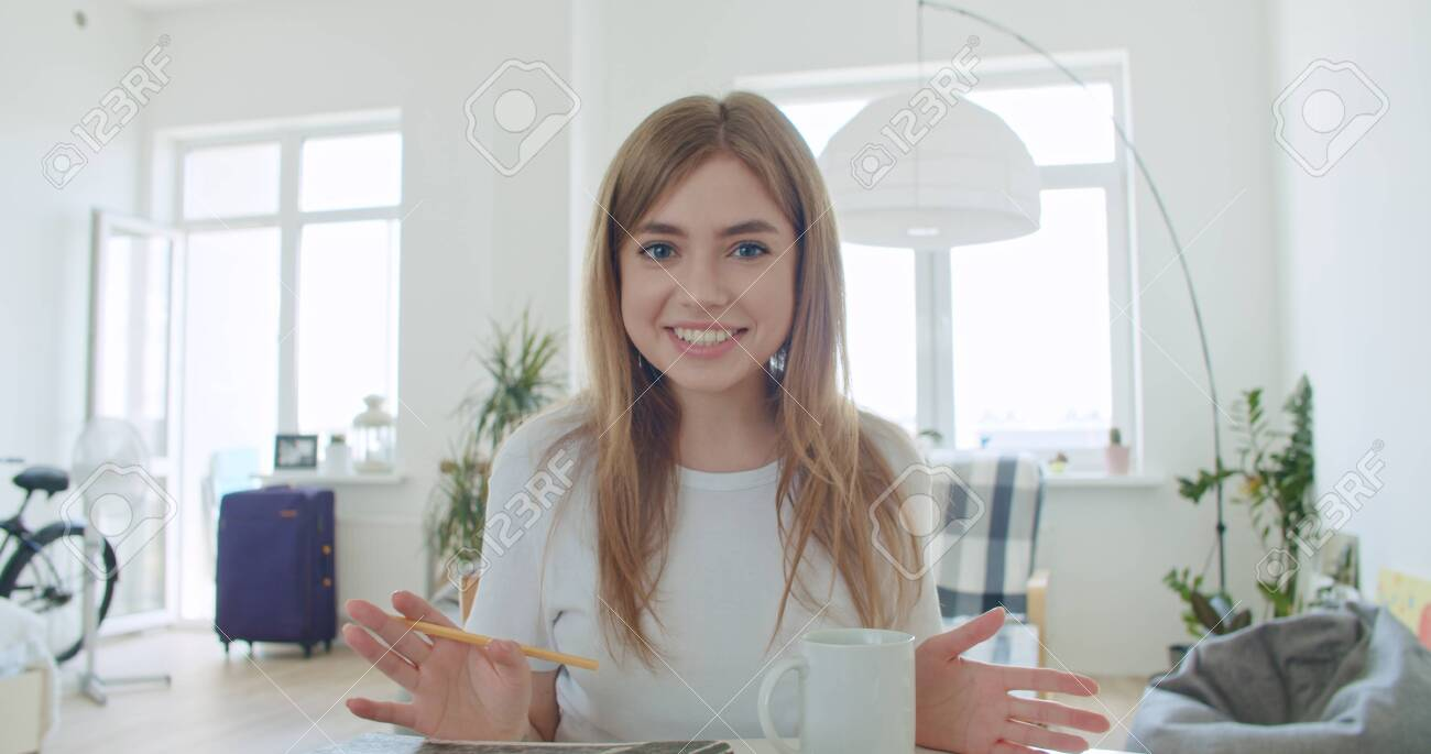 Vlogger speaking confidently to camera at home