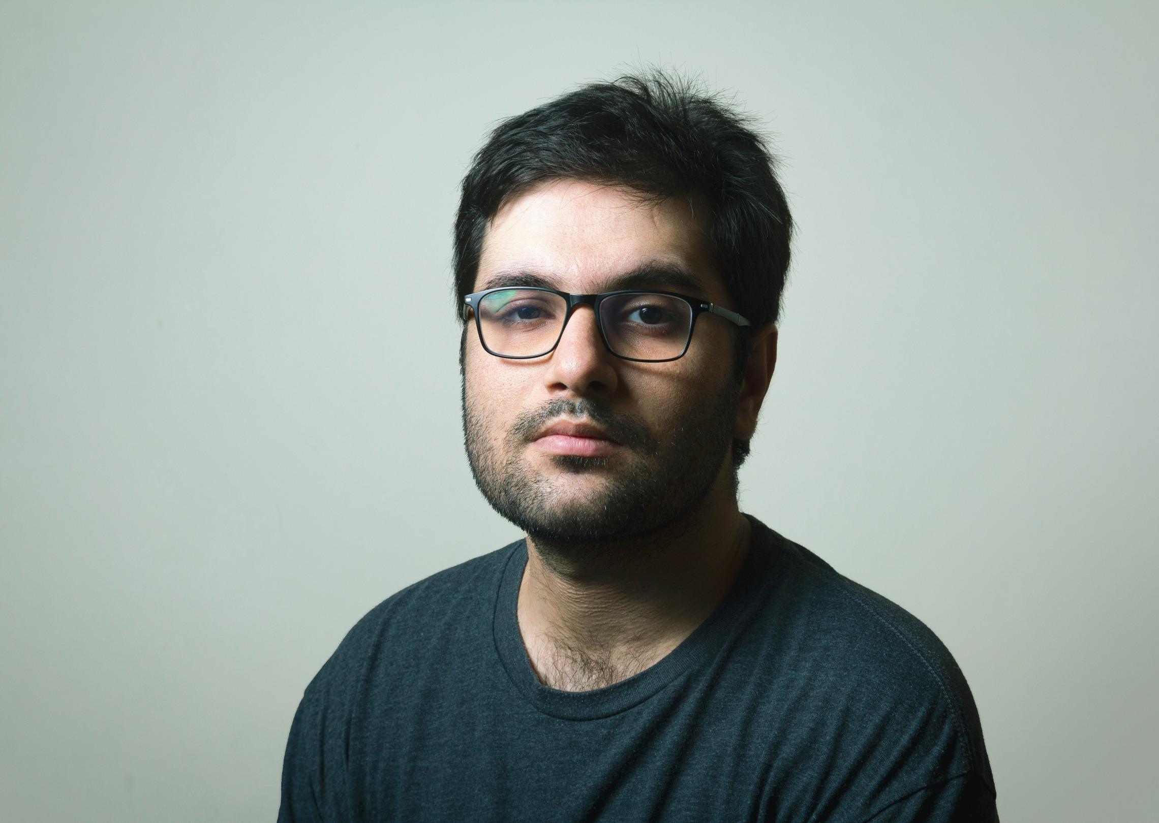 Generate a professional profile picture of a short-haired male wearing square glasses